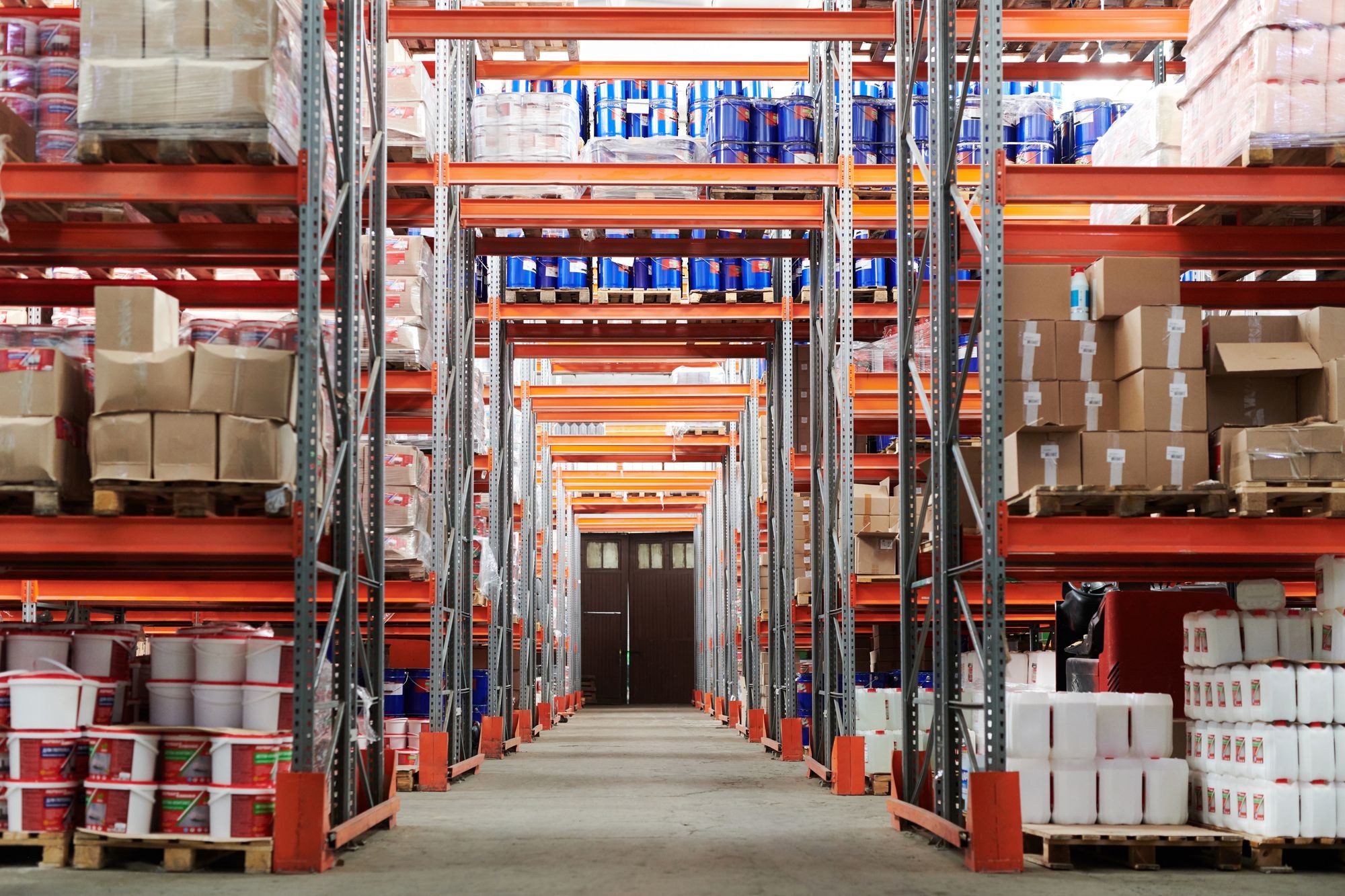 Aisle between warehouse racks holding boxes and packaged goods